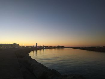 Scenic view of river against sky during sunset