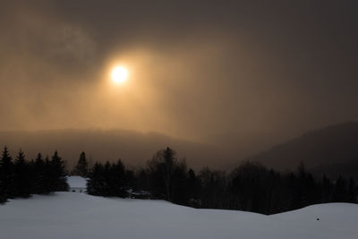 Scenic view of snow covered landscape against sky during sunset