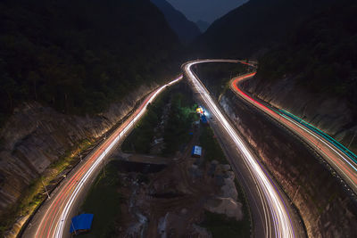 High angle view of light trails on road at night