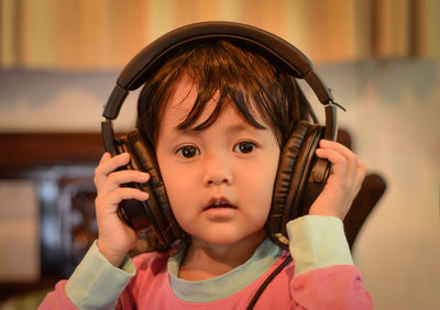 Close-up of cute girl wearing headphones
