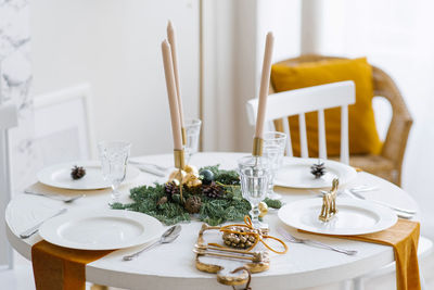 Beautiful table setting with christmas decorations in living room
