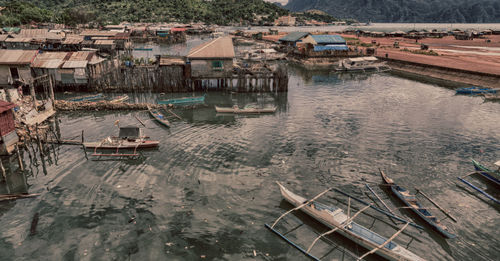 High angle view of fishing boats moored by buildings