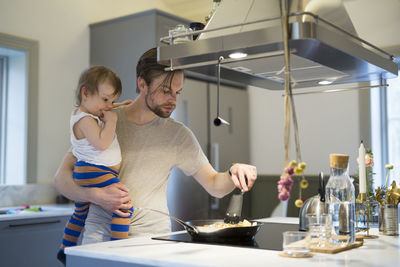 Father with daughter in kitchen