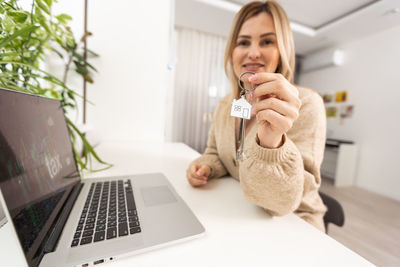 Young woman using laptop at home