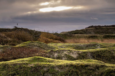 Scenic view of land against sky during sunset