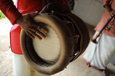 Cropped hand of man playing drum