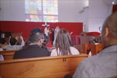 Rear view of people sitting at table