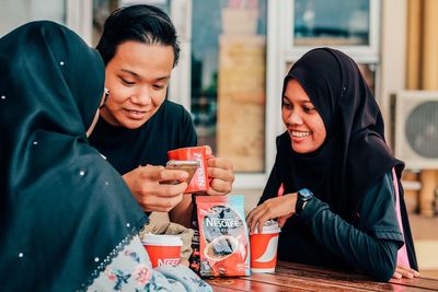 Young women sitting on table at restaurant