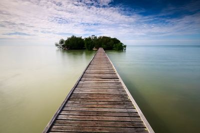 Pier over lake against sky