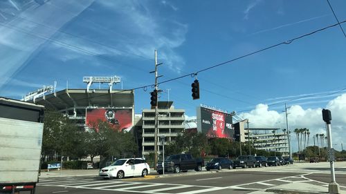 Cars in city against sky