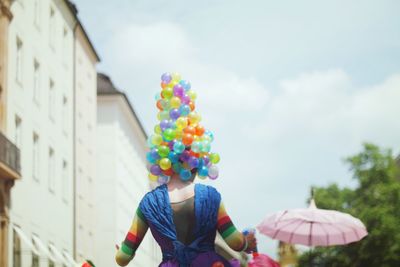 Low angle view of woman with balloons