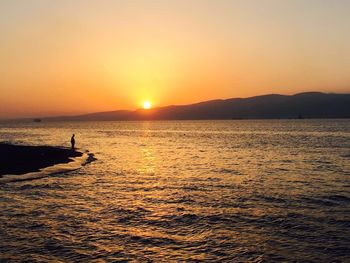 Scenic view of sea against clear sky during sunset