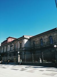 Low angle view of historical building against blue sky