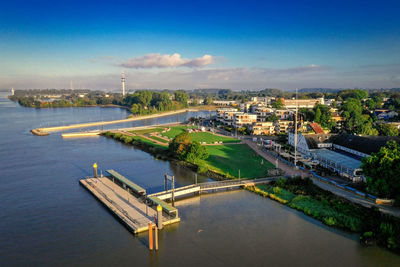 High angle view of river amidst city against sky