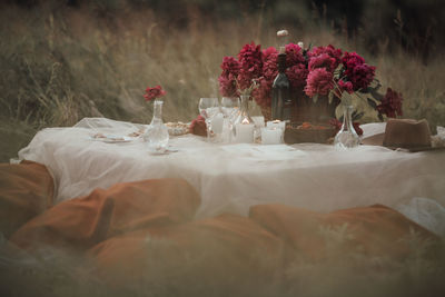 Flower vase on table against wall