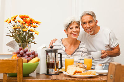 Portrait of a man eating food at home