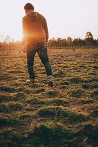Rear view of man standing on field