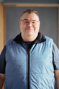 Portrait of man standing against wall