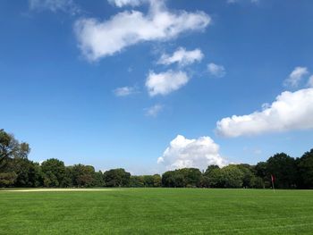 Scenic view of golf course against sky