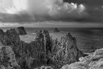 Dramatic black and white photography of rocky pen hir cape, brittany, france, with cloud sky 