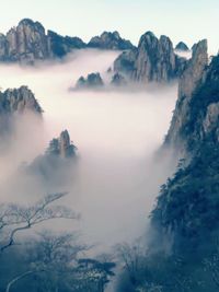 Scenic view of sea and mountains against sky