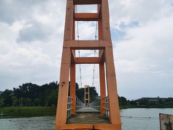 Low angle view of bridge over river against sky