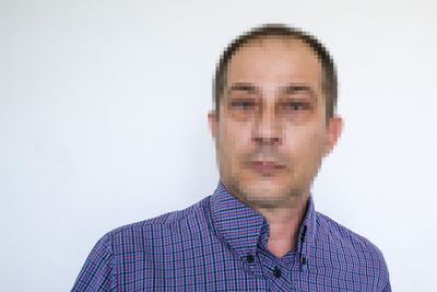 Portrait of young man against white background