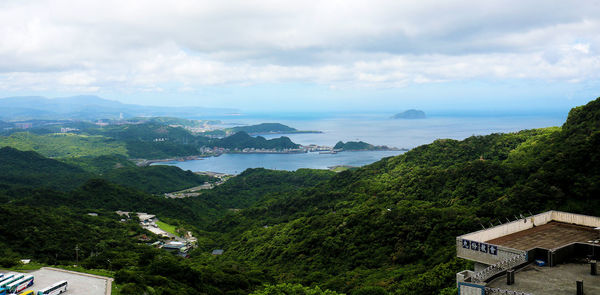 High angle view of townscape by sea against sky