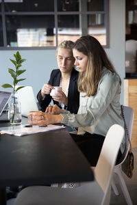 Women sitting on table in restaurant