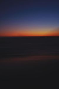 Scenic view of sea against clear sky during sunset
