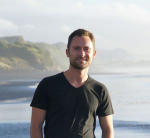 Portrait of smiling man standing against sea