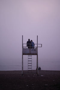 Lifeguard hut on beach against clear sky