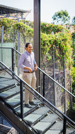 Full length of man standing on staircase outdoors