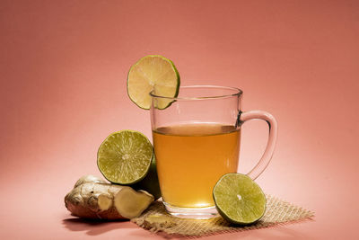 Cup of tea with lemon, ginger and honey in a table