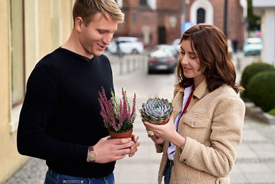 Portrait of smiling young woman holding bouquet