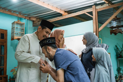 Family greeting each other during festival at home