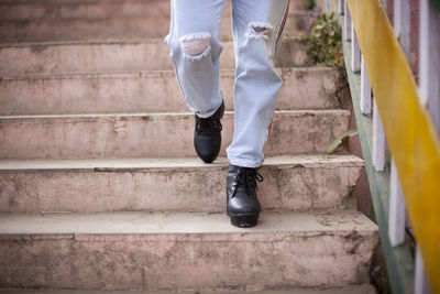 Low section of man standing on staircase
