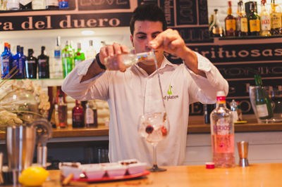 Bartender preparing drink at counter