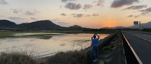 Scenic view of lake against sky during sunset