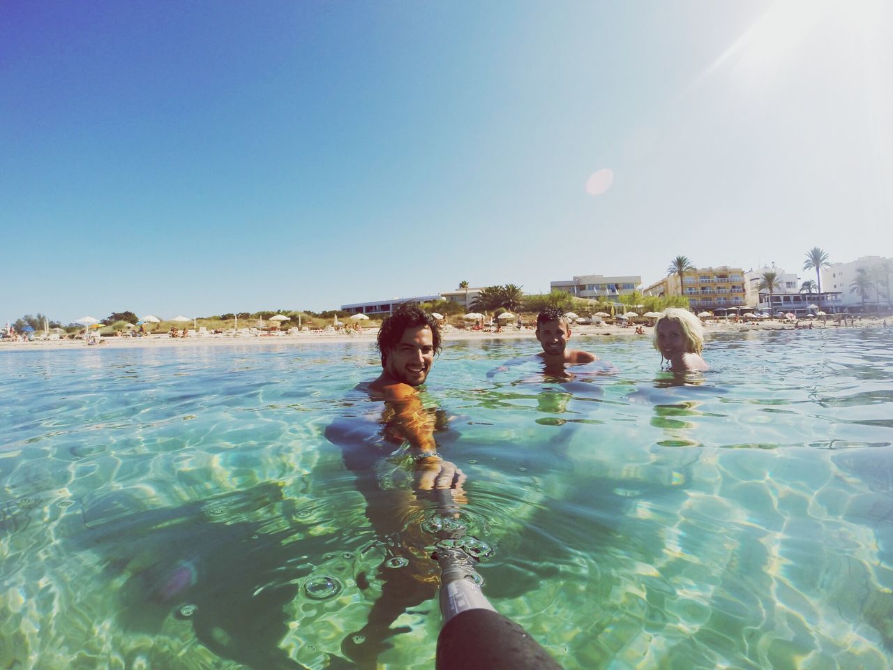 water, lifestyles, leisure activity, clear sky, sea, sunlight, blue, person, vacations, beach, nature, enjoyment, sun, young adult, sunny, copy space, day, sky