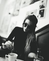 Mid adult woman having coffee at cafe