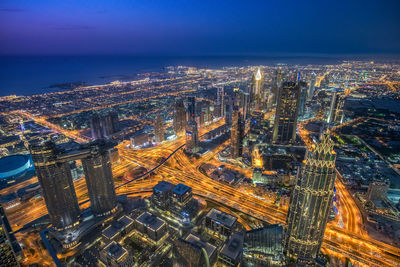 High angle view of city lit up at night