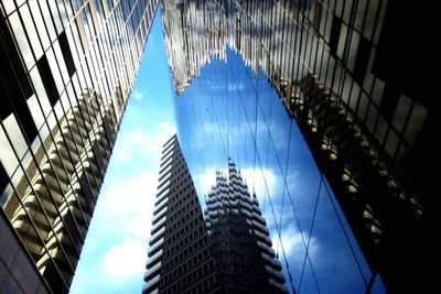 Low angle view of modern building against blue sky