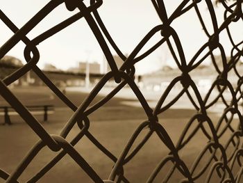 Close-up of chainlink fence against sky