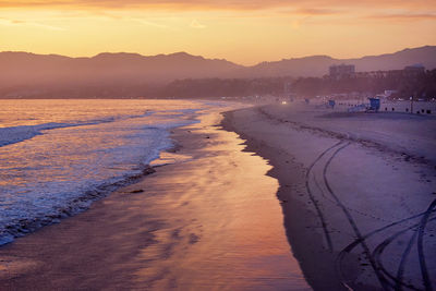 Scenic view of beach against sky during sunset