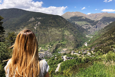 Rear view of woman against mountains and sky