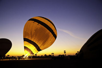 Low angle view of hot air balloon against sky at sunset