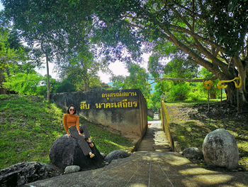 View of text on rock against trees