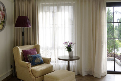 Sofa resting space by the window in a french style room with terrace