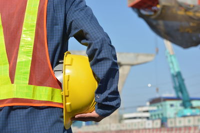 Low section of man holding umbrella